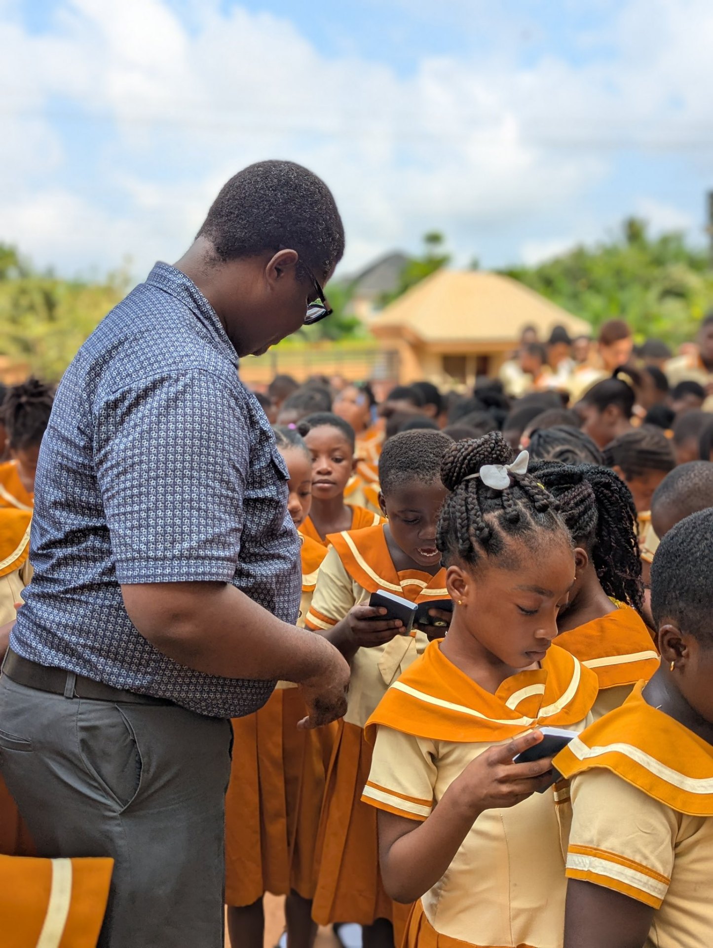 Teacher with students outdoors at KKMS